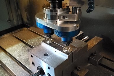 The twin spindle working on parts. 